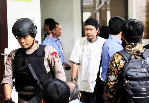 Zainal Anshori, the leader of Jamaah Ansharut Daulah (JAD), is accompanied to a courtroom for a hearing concerning the dissolution of the organisation. (Photo: The Jakata Post)