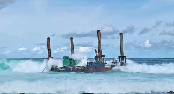 The platform used by Afcons in the construction of the Thilamalé Bridge is seen grounded on the reef of Villimalé. (Photo: PSM)