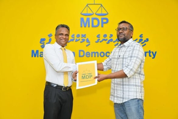 MDP Chairperson Fayyaz Ismail hands over the party ticket to former MTCC MD Adam Azim to contest for Malé City mayor on Saturday, 2 December 2023. | Photo: MDP